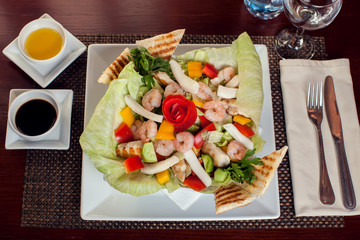 Sea food salad with sauces on white plate. Food and restaurant concept