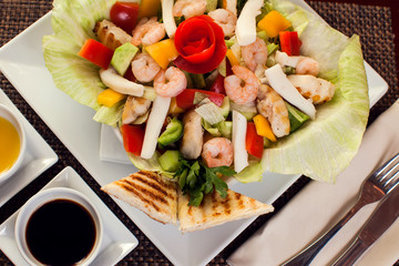 Sea food salad with sauces on white plate. Food and restaurant concept