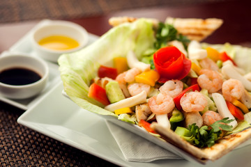 Sea food salad with sauces on white plate. Food and restaurant concept