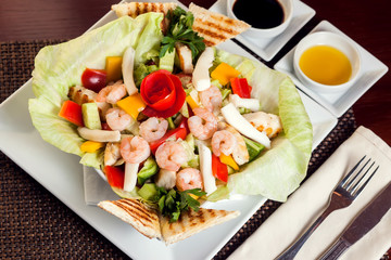 Sea food salad with sauces on white plate. Food and restaurant concept