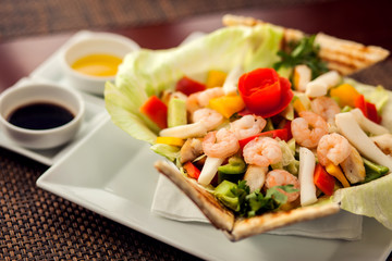 Sea food salad with sauces on white plate. Food and restaurant concept