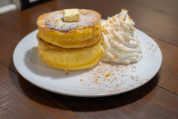 Fluffy Japan souffle pancakes, hotcakes with honey syrup and butter light concrete background copy space