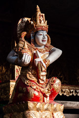 Colorful Balinese Goddess Statue hit by direct sunrays, Ubud, Bali, Indonesia