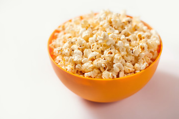 Fototapeta na wymiar A bowl with popcorn isolated on white background. Food concept