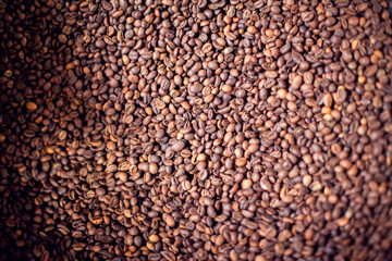 Roasted brown coffee beans pattern, background, top view texture. Organic food concept