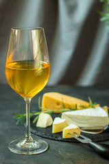 white wine in a glass and cheese. food background. top drink