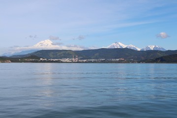Avachinsky and Koryaksky volcanoes towers over the city of Petropavlovsk-Kamchatsky on the Kamchatka Peninsula, Russia.