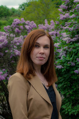 Happy Hipster Girl Using Tablet Outdoors. walk in the lilac bloom