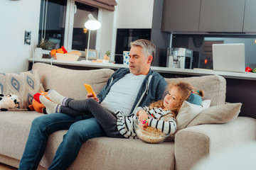 Adorable small long-haired girl and her father spending evening together