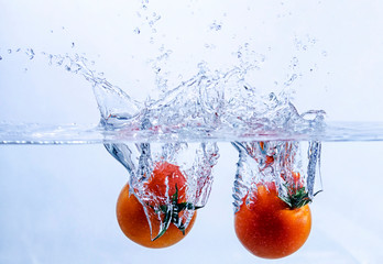 Pair of Tomatoes Splashing into Water