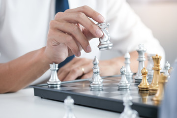 Businessman play with chess game. success management concept of business strategy and tactic...
