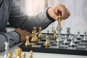 Businessman play with chess game. success management concept of business strategy and tactic...