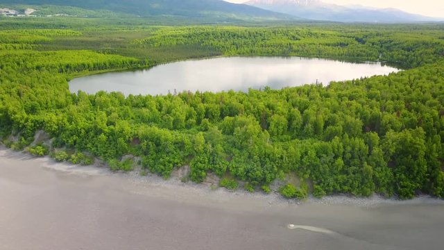 Aerial view of water reservatory near muddy shore, Kachemak bay, Alaska.