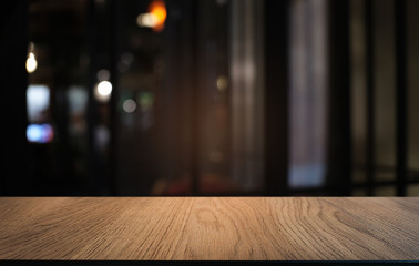 Empty dark wooden table in front of abstract blurred bokeh background of restaurant . can be used for display or montage your products.Mock up for space.