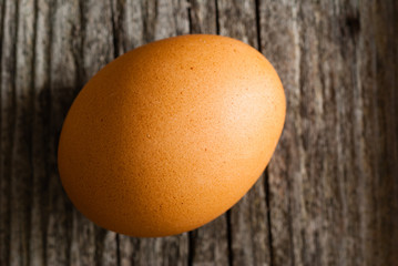 single egg on weathered wooden table