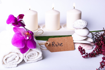 A collection of wellness items and a heart built out of branches and a tag saying "Ruhe" silence in German