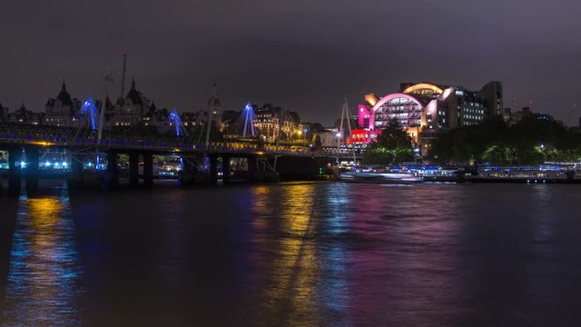 Night London Charing Cross station and Hungerford Bridge, reflection night lights. Time lapse.