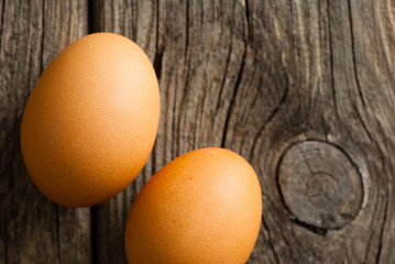 two eggs on weathered wooden table