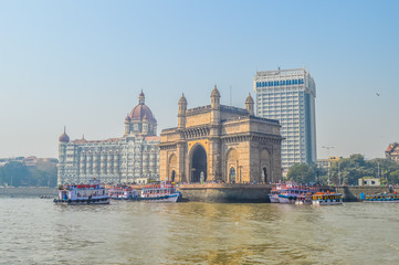 Beautiful Gateway of India near Taj Palace hotel on the Mumbai harbour with many jetties on Arabian sea