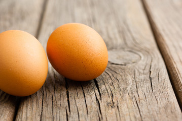 two eggs on weathered wooden table