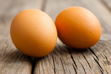 two eggs on weathered wooden table