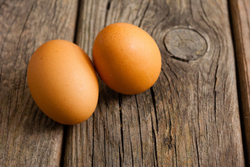 two eggs on weathered wooden table