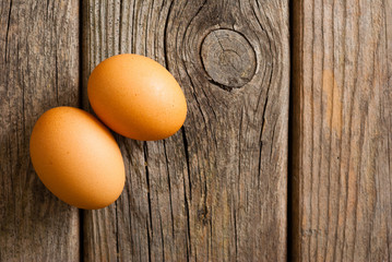 two eggs on weathered wooden table
