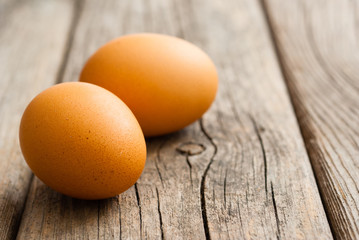 two eggs on weathered wooden table