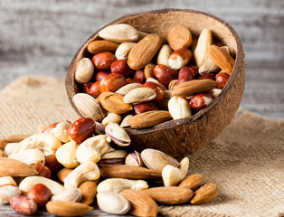 Healthy mix nuts on wooden background. Almonds, hazelnuts, cashews, peanuts, pistachios, brazilian nuts