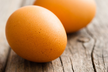 two eggs on weathered wooden table