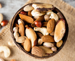 Healthy mix nuts on wooden background. Almonds, hazelnuts, cashews, peanuts, pistachios, brazilian nuts