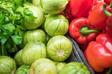 Fresh vegetables in a food market - red peppers and zucchini