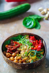 Vegan Buddha bowl with chickpeas, courgette, sundried tomatoes and sprouts