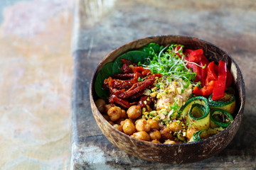 Vegan Buddha bowl with chickpeas, courgette, sundried tomatoes and sprouts