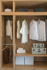 modern closet with clothes hanging