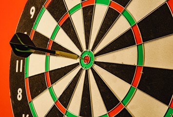 darts game one black arrows on a red background.
