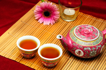 China tea set with pink daisy flower and candle like oriental Chinese tea concept 