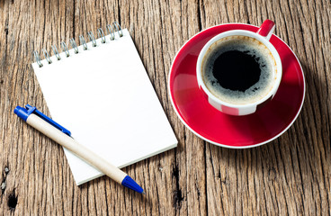 Blank note paper with pen and espresso coffee cup on old wood table