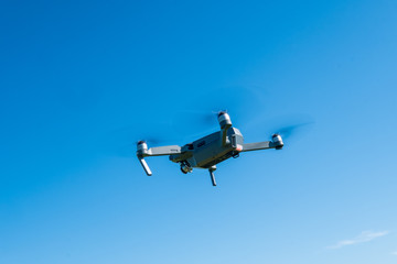 Fototapeta na wymiar Folding drone flying in a sky