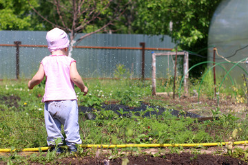 A little happy girl in the garden