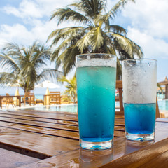 Two glasses with a bright blue drink on the table on the hotel terrace.