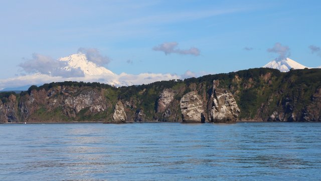 View of Tri Brata with Avachinsky and Koryaksky volcanoes in the background. Tri Brata (Russian: Три Брата; literally: "three brothers") is a set of three rocks at the entrance to the Avacha Bay.