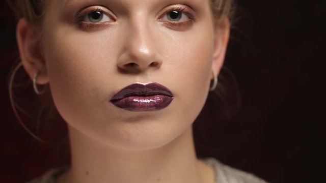 Portrait of a cute girl with professional make-up and beautiful lips close-up