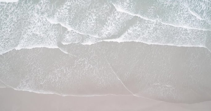 Crashing waves on beach top aerial view