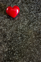 red heart on black and white granite