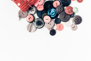 Colorful sewing buttons on white background closeup with copy space for text.