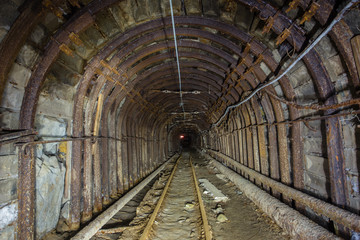 Fototapeta na wymiar Underground abandoned gold iron ore mine shaft tunnel gallery passage wtih metal timbering