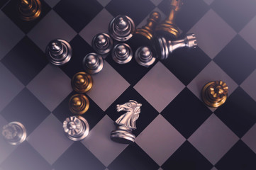 Chess pieces knights facing each other for a standoff. Chess knights confronting each other.