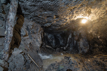 Underground gold ore emerald mine shaft tunnel gallery passage with mining face