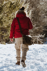a photographer in the mountains on the snow in winter - concept of wildlife and nature photography - nature lovers